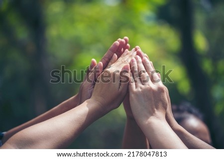 Diversity multiethnic high five group of business people success team hands together. Collaborate Volunteer friendship hands raise up mission Business partner. Group of teamwork high five together