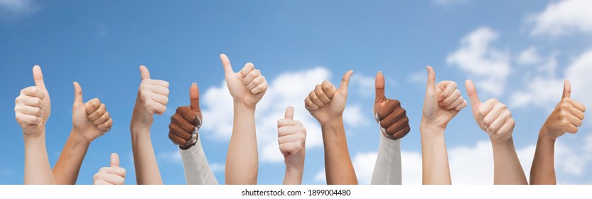 Diversity, Multiethnic And International Concept - Hands Of People With Diverse Ethnicity Showing Thumbs Up On Blue Sky And Clouds Background