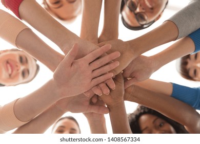 diversity, race, ethnicity and people concept - close up of happy international women stacking hands