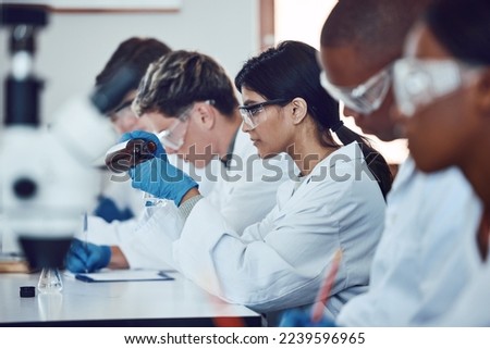 Diversity, scientist and people in science exam, test or group project in experiment or assignment at laboratory. PHD students in scientific research, chemical or forensics with safety uniform in lab