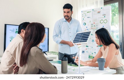 Diversity team presentation new design solar cell panel renewable energy innovation at office  - Powered by Shutterstock