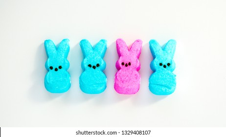 diversity-four pink and turquoise marshmallow peep Easter bunnies isolated on a white background
