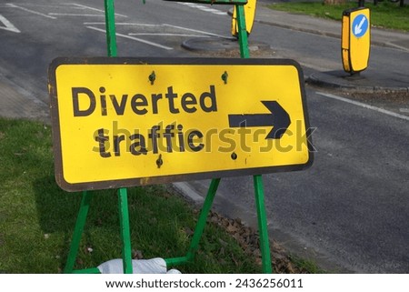 Diverted traffic road sign with arrow. informative sign for motorists at works site showing reroute 