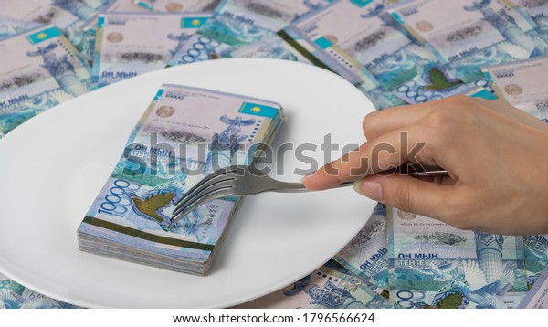 Divide the budget. Kazakhstan banks and loans in\
tenge.A lot of Kazakhstan tenge in a circle on the table. The\
national currency of Kazakhstan. Salary in tenge. Grocery basket,\
budget savings.
