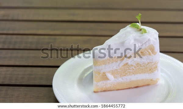 Divided coconut cake To fit customer needs Ready to\
be served on a wooden\
table