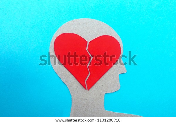 A divided heart in the mind
thoughts of failed love, a silhouette of a man blue
background