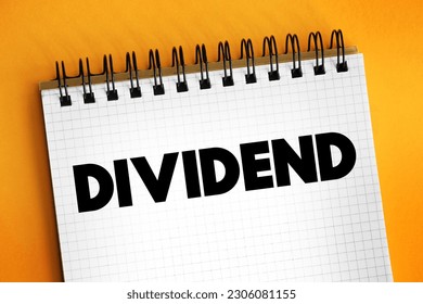 Dividend - distribution of profits by a corporation to its shareholders, text concept on notepad