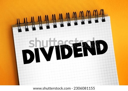 Dividend - distribution of profits by a corporation to its shareholders, text concept on notepad