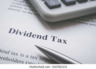 Dividend Tax Information Page, Calculator And Pen.