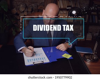  DIVIDEND TAX Text In Footnote Block. Bookkeeping Clerk Checking Financial Report A dividend Tax is A tax imposed By A Jurisdiction On dividends paid By A Corporation To Its Shareholders.
