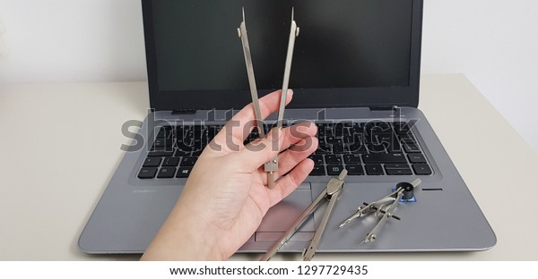 dividers in woman hand and\
laptop