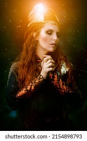 Divine Female Warrior Valkyrie Praying With Her Hands Clasped In Front Of Her. Epic Fantasy. Scandinavian Mythology. Starry Night Sky Background. 