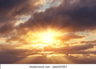 Divine glow through the clouds of the evening warm sun. Concept of peace and happiness. - Powered by Shutterstock