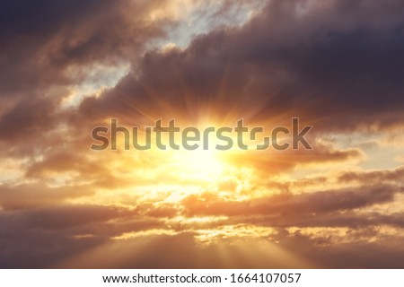 Divine glow through the clouds of the evening warm sun. Concept of peace and happiness.
