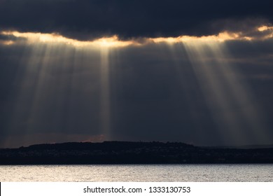 Divine Light Shining Through Dark Clouds, Mighty Cloudscape Sea View.