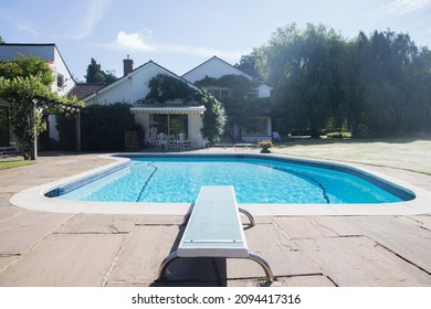 Diving Board At The Edge Of Swimming Pool