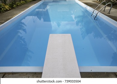 Diving Board At An Empty, Blue Pool