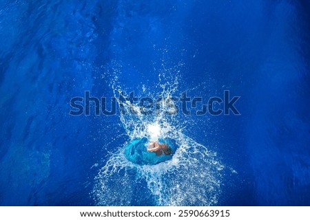 Diving board high diver jumping into the swimming pool with water splash