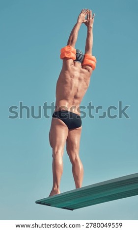 Diving board, man and ready by blue sky for swimming, exercise or water sports in swimwear by space. Male person, swimmer and balance with back of diver in gear outdoor for wellness in low angle