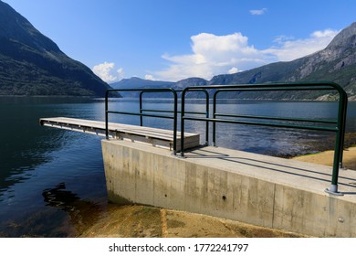 Diving Board On The Shore Of A Spectacular Norwegian Fjord, With Calm Water And A Mountain Backdrop, On A Beautiful Sunny Day In Summer, Eidfjord, Hardangerfjord, Hordaland, Norway 