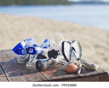 Diving Goggle And Equipment On Table And Beach