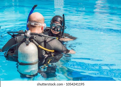 Diving instructor and students. Instructor teaches students to dive