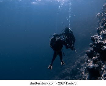 Diving instructor and students in underwater exercise. Scuba diving education and training in Tomia Island, Wakatobi, South Sulawesi, Indonesia