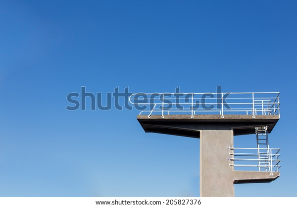 Diving platform\
from the side with a blue\
sky