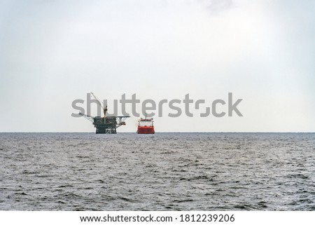 A diving support vessel alongside a platform at Terengganu oil field.