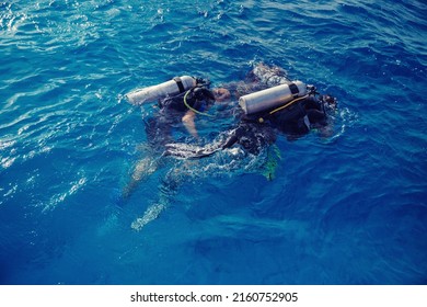 Diving Training, Instructor Instructs Tourists To Dive Underwater With Scuba Diving In Sea, Top View.