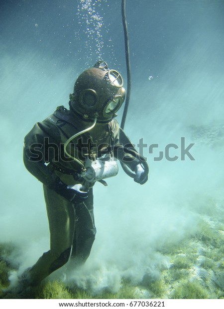 Diving with a vintage\
diving suite        