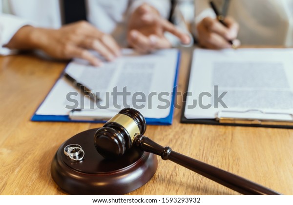 Divorce agreement. Lawyer Consultant with\
customer in courtroom.
