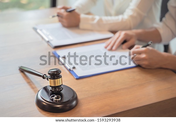 Divorce agreement. Lawyer Consultant with
customer in courtroom.