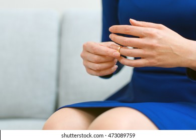 Divorce Concept. Woman Taking Off Wedding Ring.