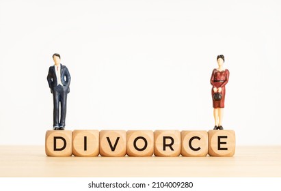 Divorce concept. Word on Wooden cube block and woman and man figurines. Copy space