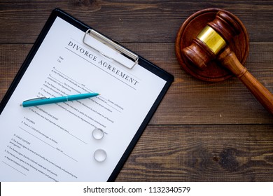 Divorce Court Case. Divorce Agreement Near Wedding Rings And Judge Gavel On Dark Wooden Background Top View Copy Space