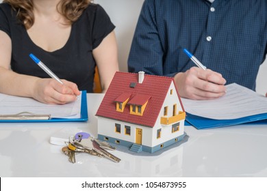 Divorce and dividing a property concept. Man and woman are signing divorce agreement.