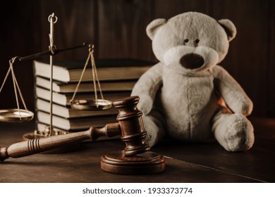 Divorce At Family And Alimony Concept. Wooden Gavel And Teddy Bear As Symbol Of Child On A Desk