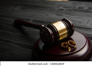 Divorce And Separation Concept. Two Golden Wedding Rings, Judge Gavel.