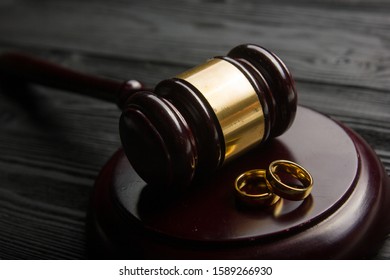 Divorce And Separation Concept. Two Golden Wedding Rings, Judge Gavel.