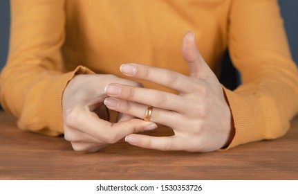 Divorce; Woman Removes A Wedding Ring From Her Finger