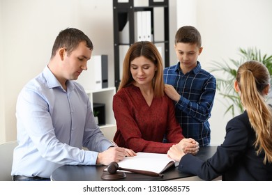 Divorced parents with their son visiting lawyer. Concept of child support