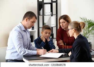 Divorced parents with their son visiting lawyer. Concept of child support
