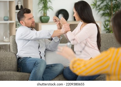 Divorcing Young Couple Arguing In Psychiatrist Office