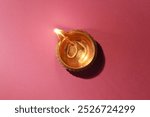 Diwali celebration. Diya lamp on color background, top view