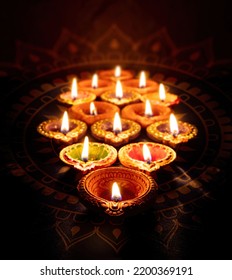 Diwali. Deepavali Hindu festival of lights. Clay diya candle. Oil lamp lit on dark background
