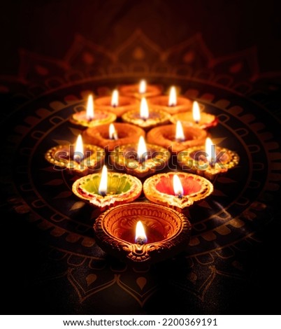Diwali. Deepavali Hindu festival of lights. Clay diya candle. Oil lamp lit on dark background

