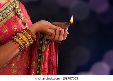 Diwali Or Deepavali Photo With Female Hands Holding Oil Lamp During Festival Of Light