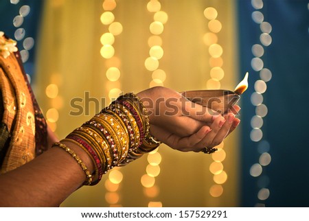 diwali festival of lights , hands holding indian oil lamp
