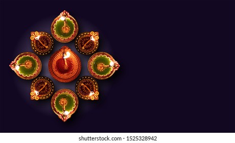 Diwali, Hindu festival of lights celebration. Clay diya colorful illuminated in Dipavali, Traditional oil lamps on dark background, top view, copy space - Powered by Shutterstock